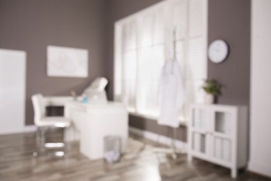 Photo of Blurred view of modern medical office with doctor's workplace. Interior design