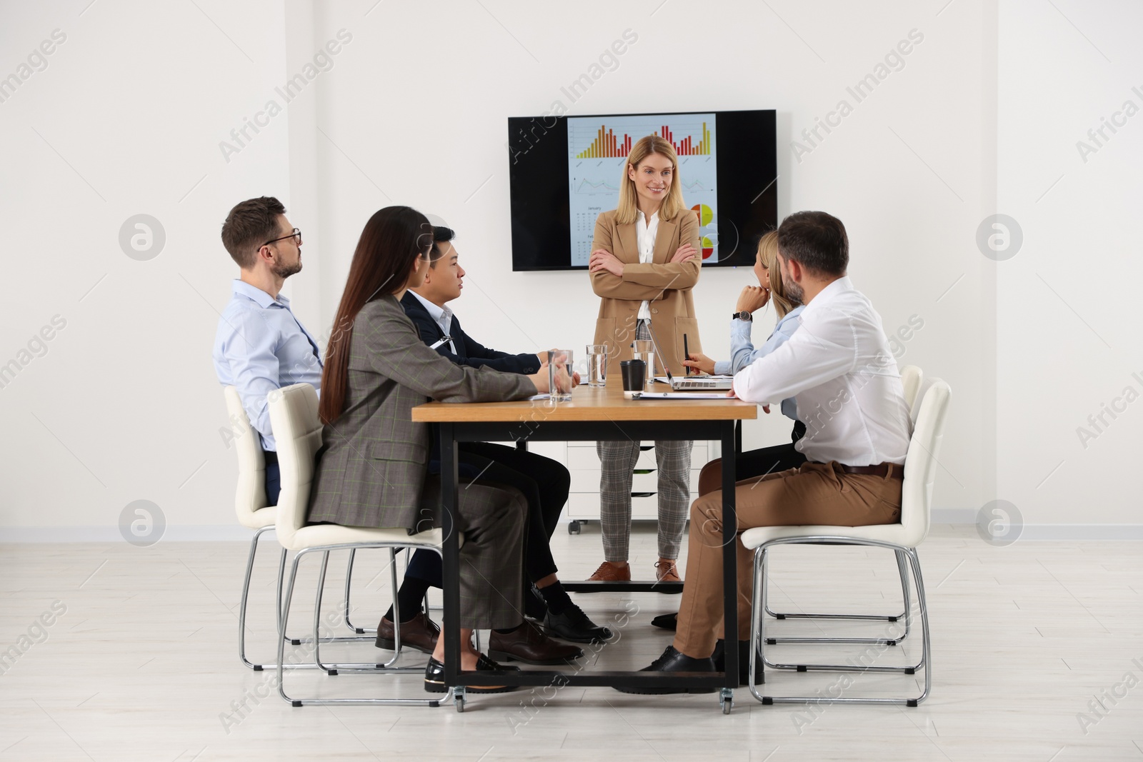 Photo of Businesswoman having meeting with her employees in office