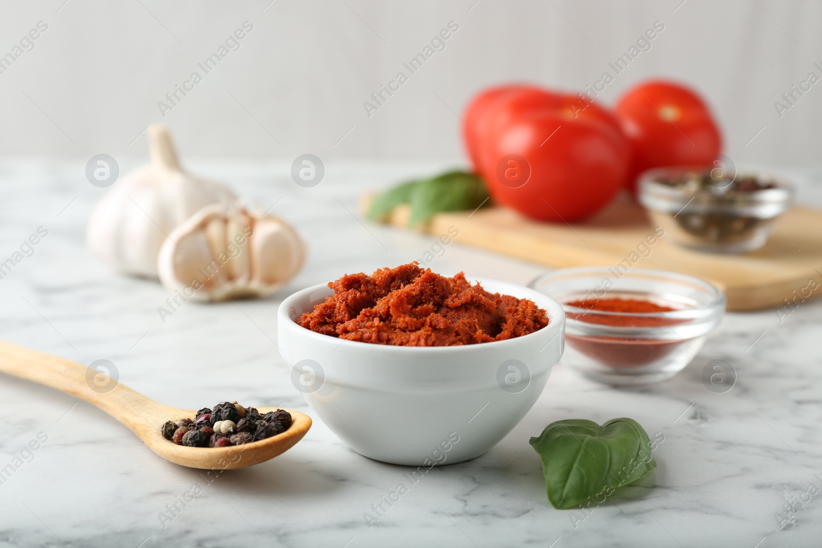 Photo of Red curry paste and ingredients on white marble table