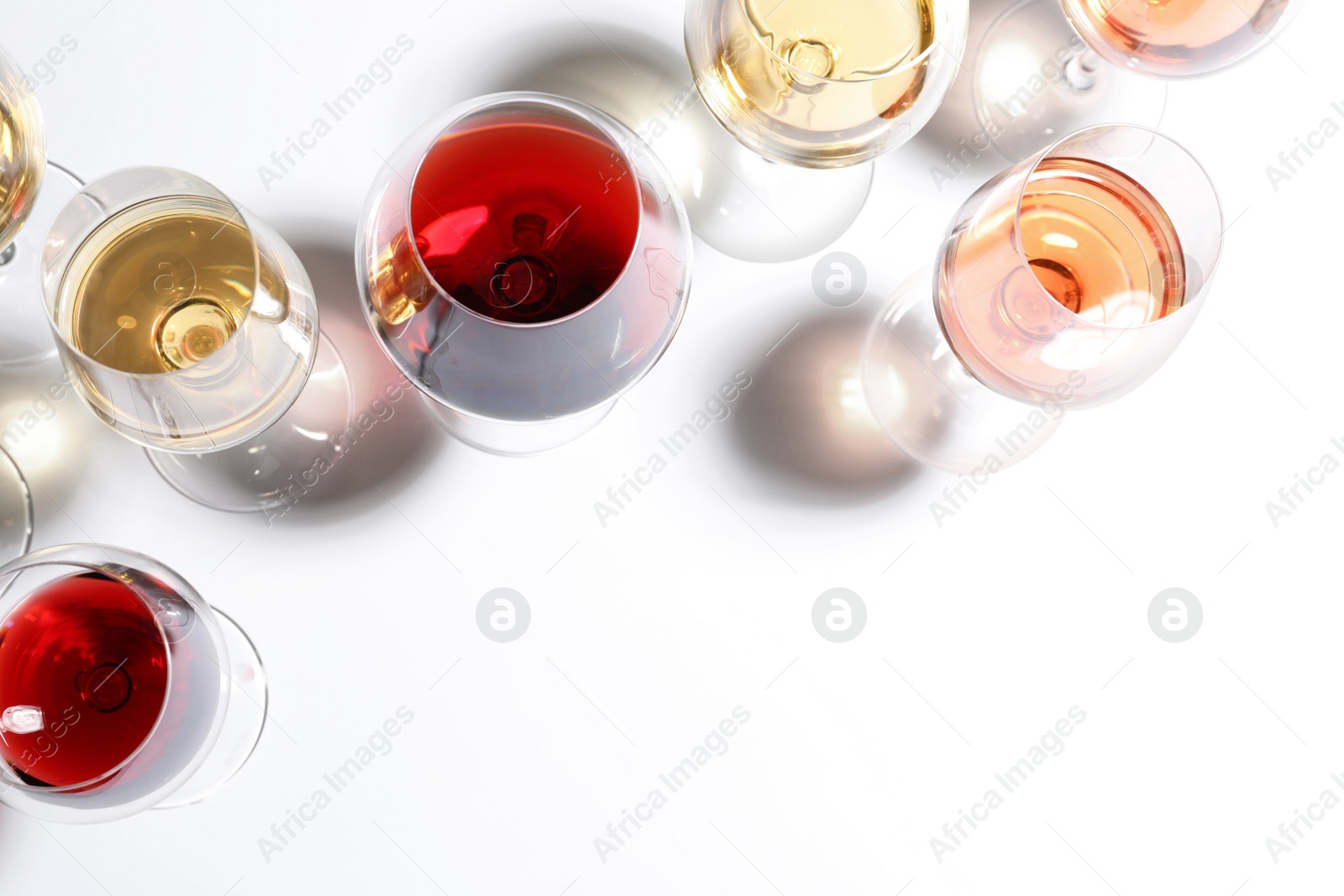 Photo of Different glasses with wine on white background, top view