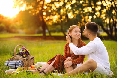 Photo of Happy young couple having picnic in park