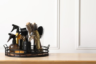 Photo of Set of hairdresser tools on table in salon, space for text