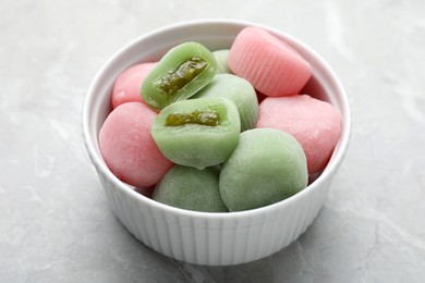 Photo of Delicious mochi in bowl on light grey marble table. Traditional Japanese dessert