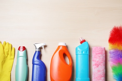 Photo of Flat lay composition with cleaning supplies on wooden background