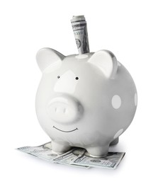 Photo of Piggy bank and banknotes on white background