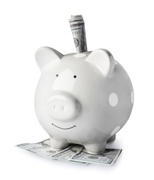 Piggy bank and banknotes on white background