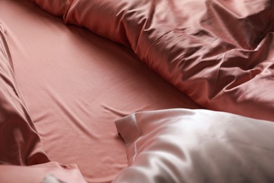 Photo of Closeup view of bed with beautiful silk linens