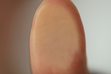 Closeup view of person scanning fingerprint on blurred background