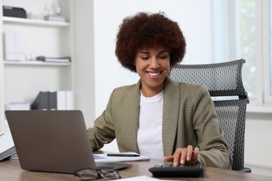 Professional accountant working at wooden desk in office