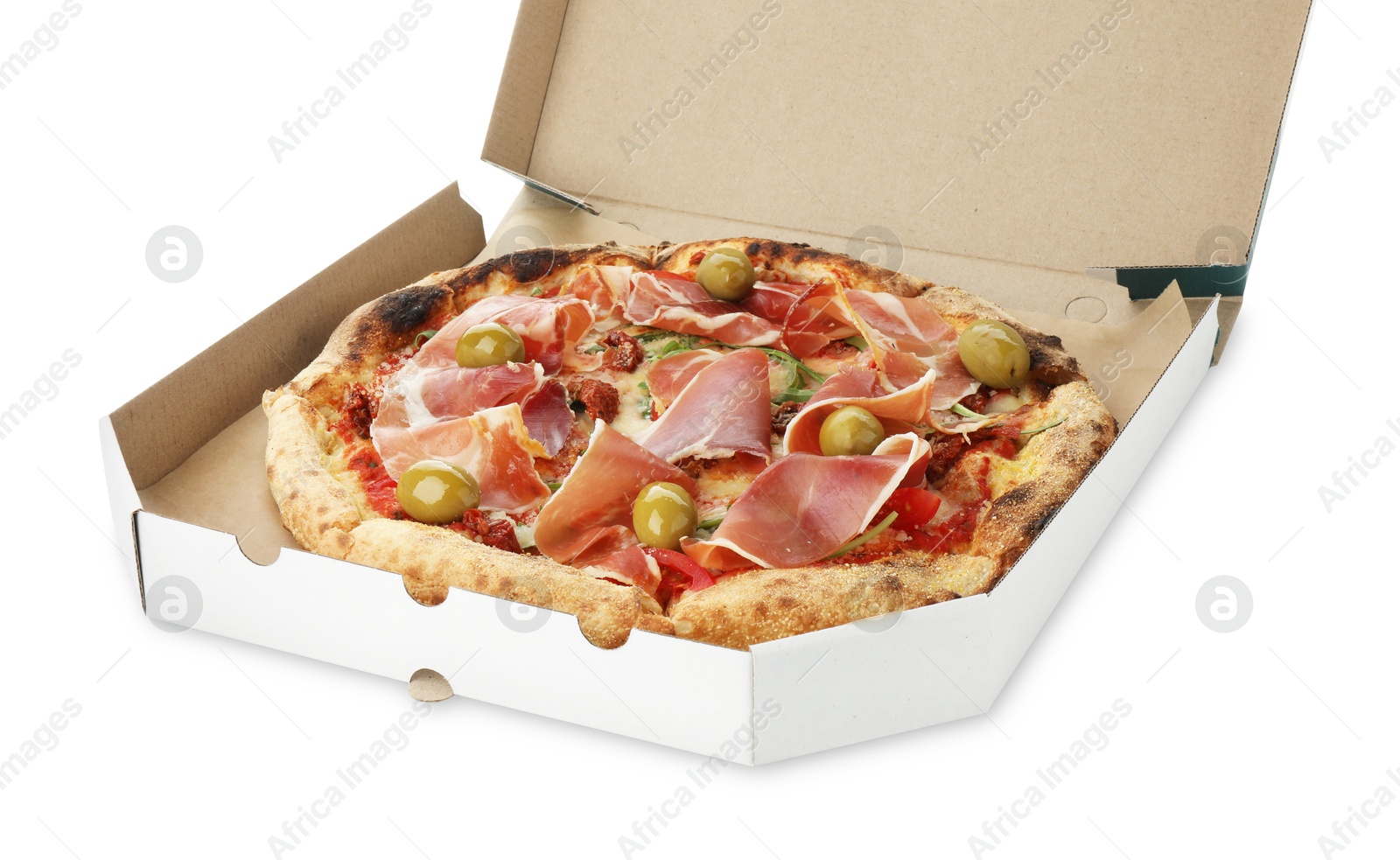 Photo of Tasty pizza with cured ham, olives and sun-dried tomato in cardboard box isolated on white