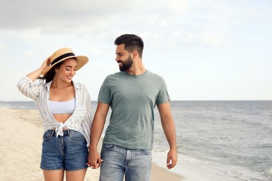 Photo of Lovely couple spending time together on beach