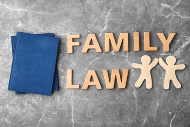 Flat lay composition with words FAMILY LAW on grey background