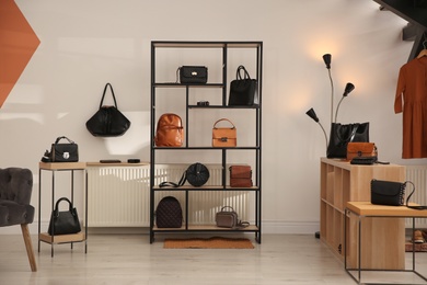 Photo of Collection of stylish women's bags and accessories in luxury boutique