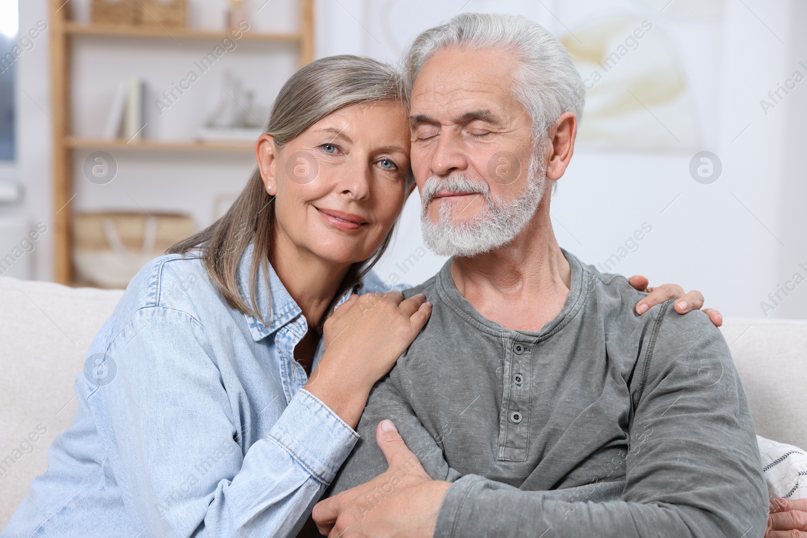 Photo of Portrait of affectionate senior couple at home