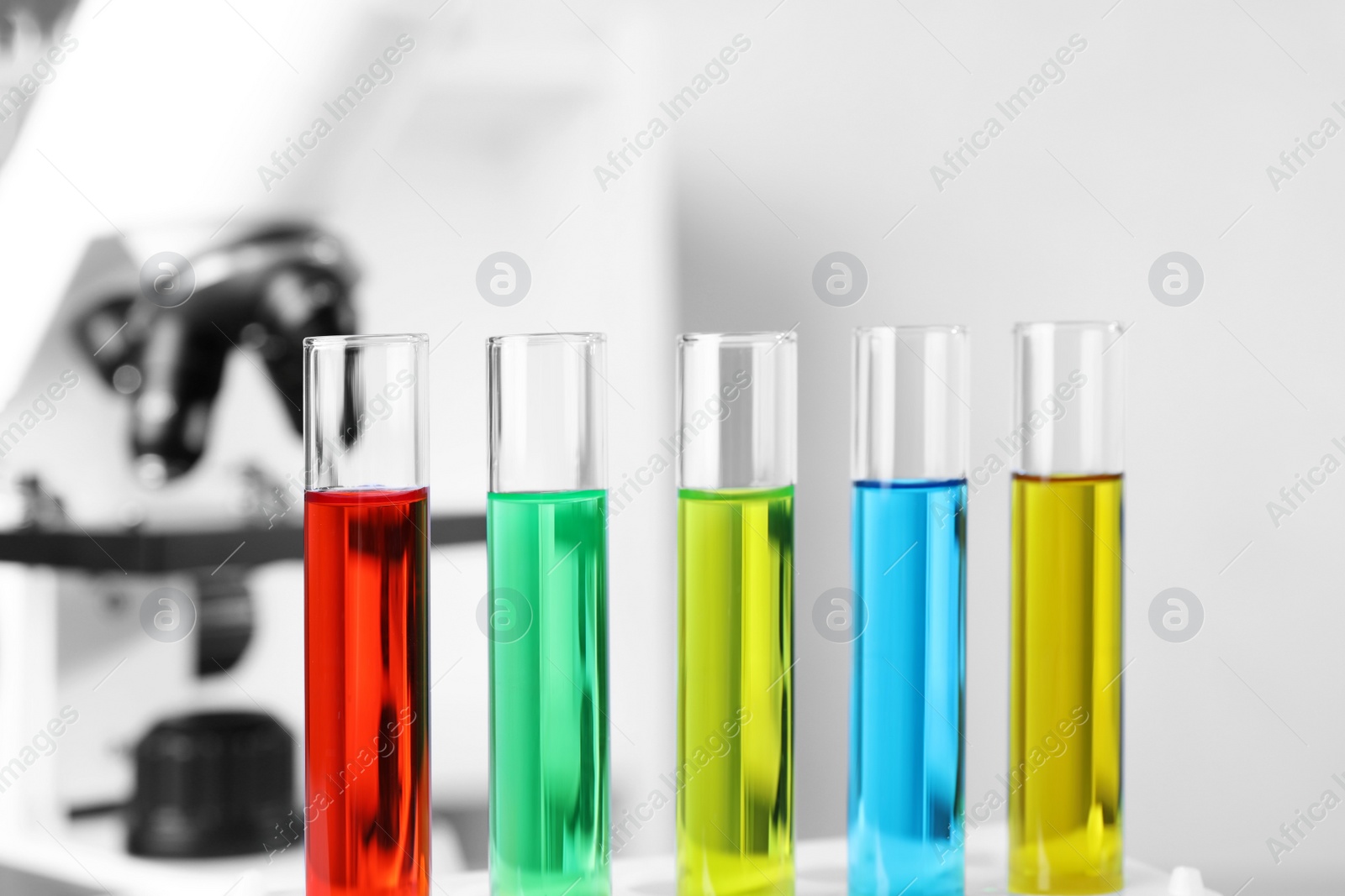 Photo of Many test tubes with samples in chemistry laboratory, closeup