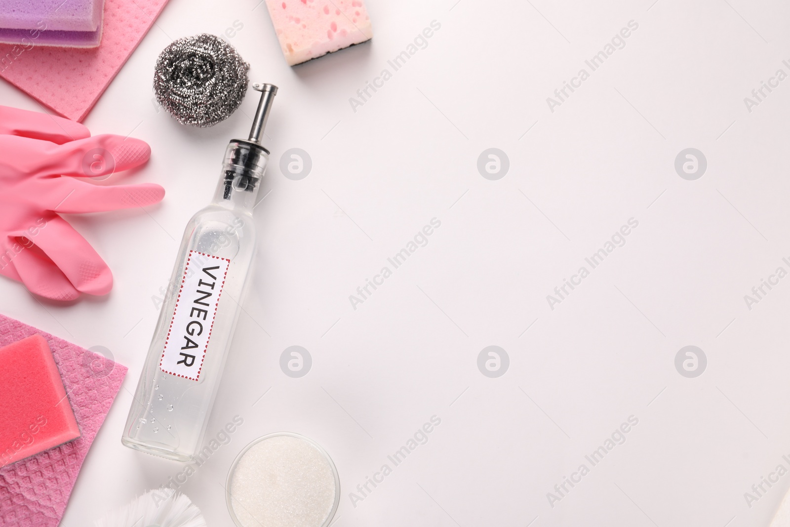 Photo of Eco friendly natural cleaners. Flat lay composition with bottle of vinegar on white background, space for text