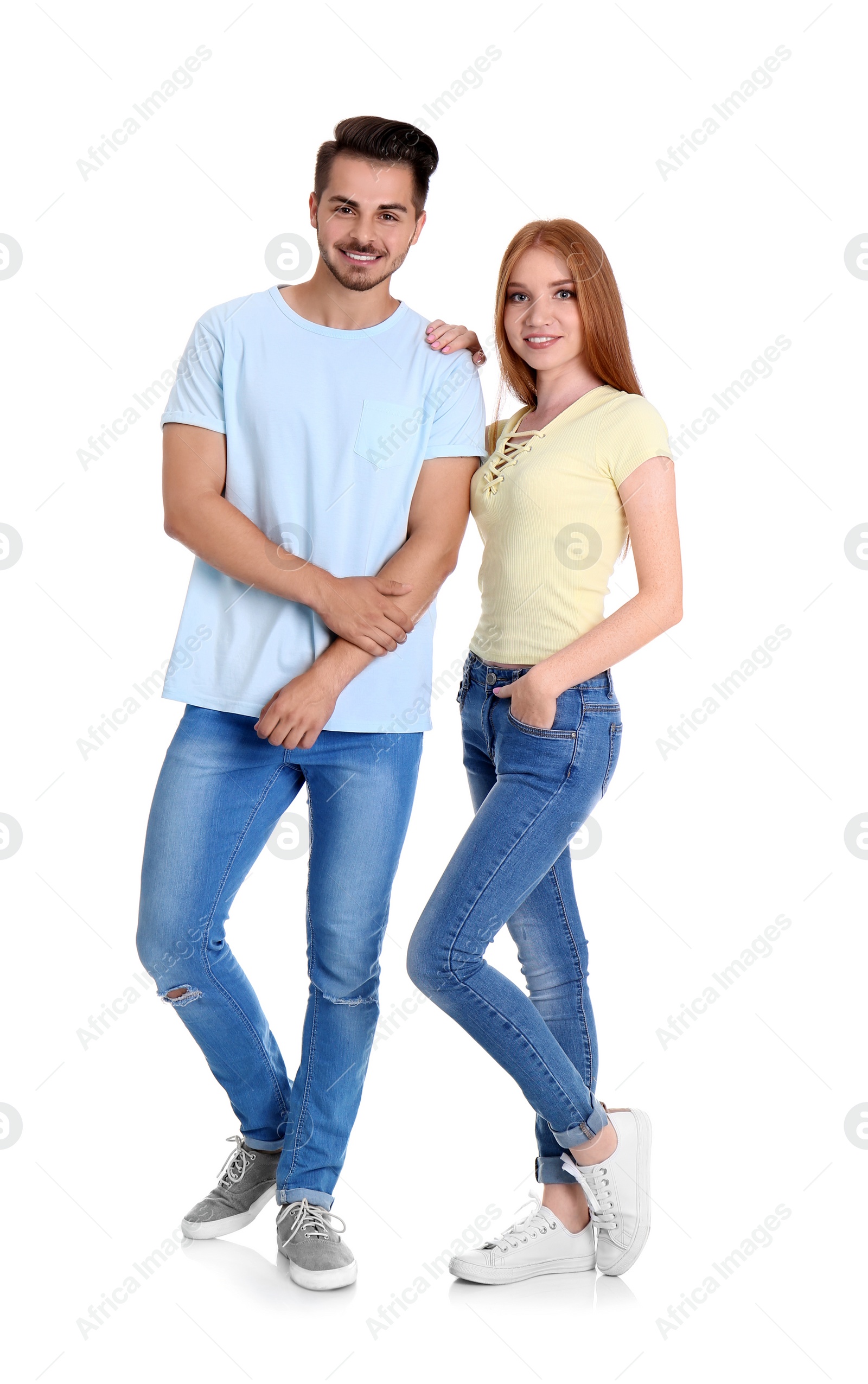 Photo of Young couple in stylish jeans on white background