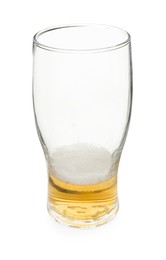 Almost empty glass of beer isolated on white