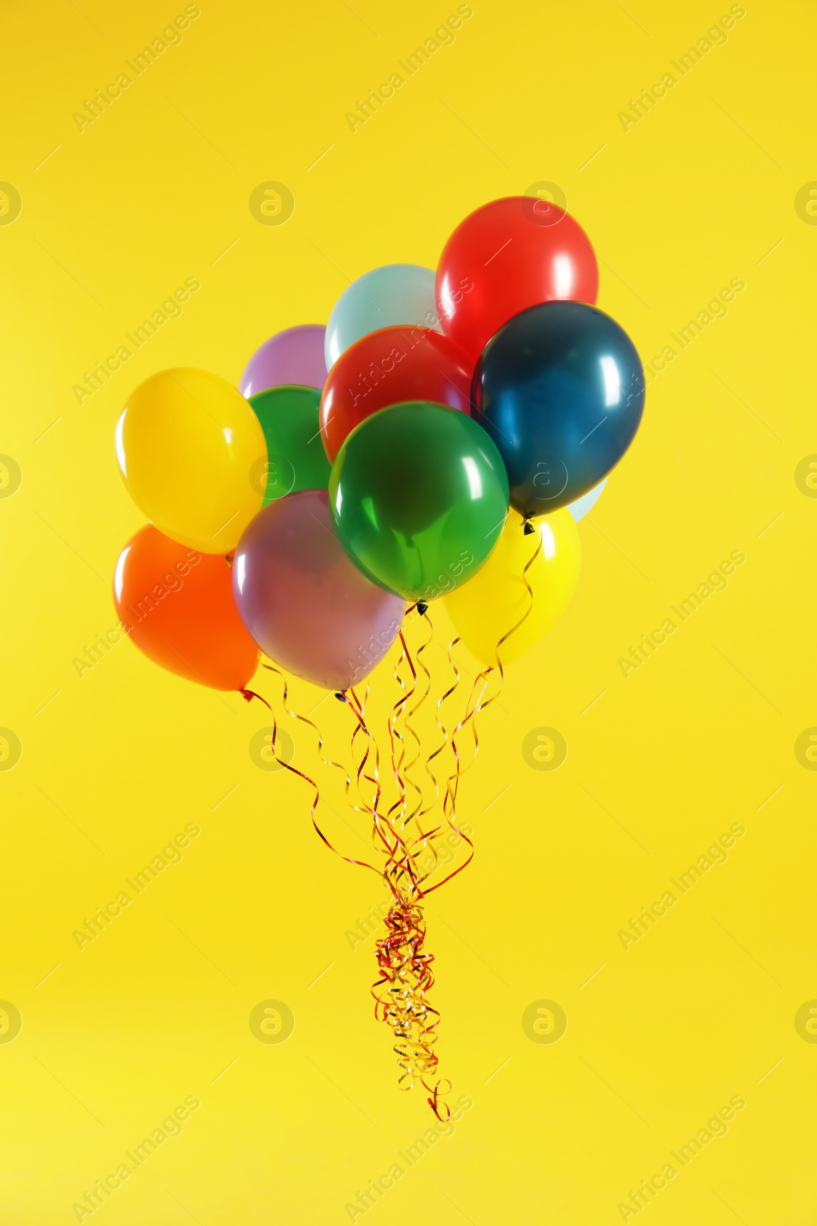 Photo of Bunch of bright balloons on color background. Celebration time