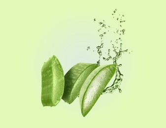 Image of Sliced aloe vera leaf and splashes of juice on green background