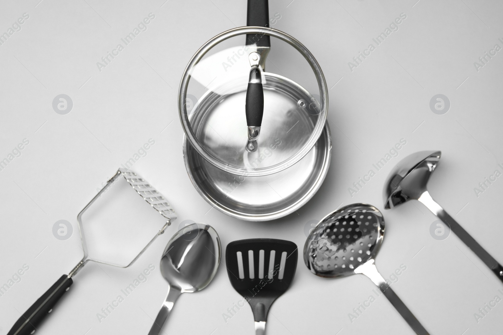 Photo of Set of modern cooking utensils on light grey background, flat lay