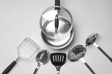 Set of modern cooking utensils on light grey background, flat lay