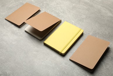 Photo of Yellow and brown planners on grey table