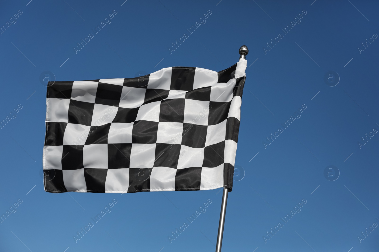 Photo of Checkered finish flag on light blue background