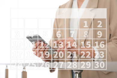 Calendar and woman with modern smartphone indoors, closeup