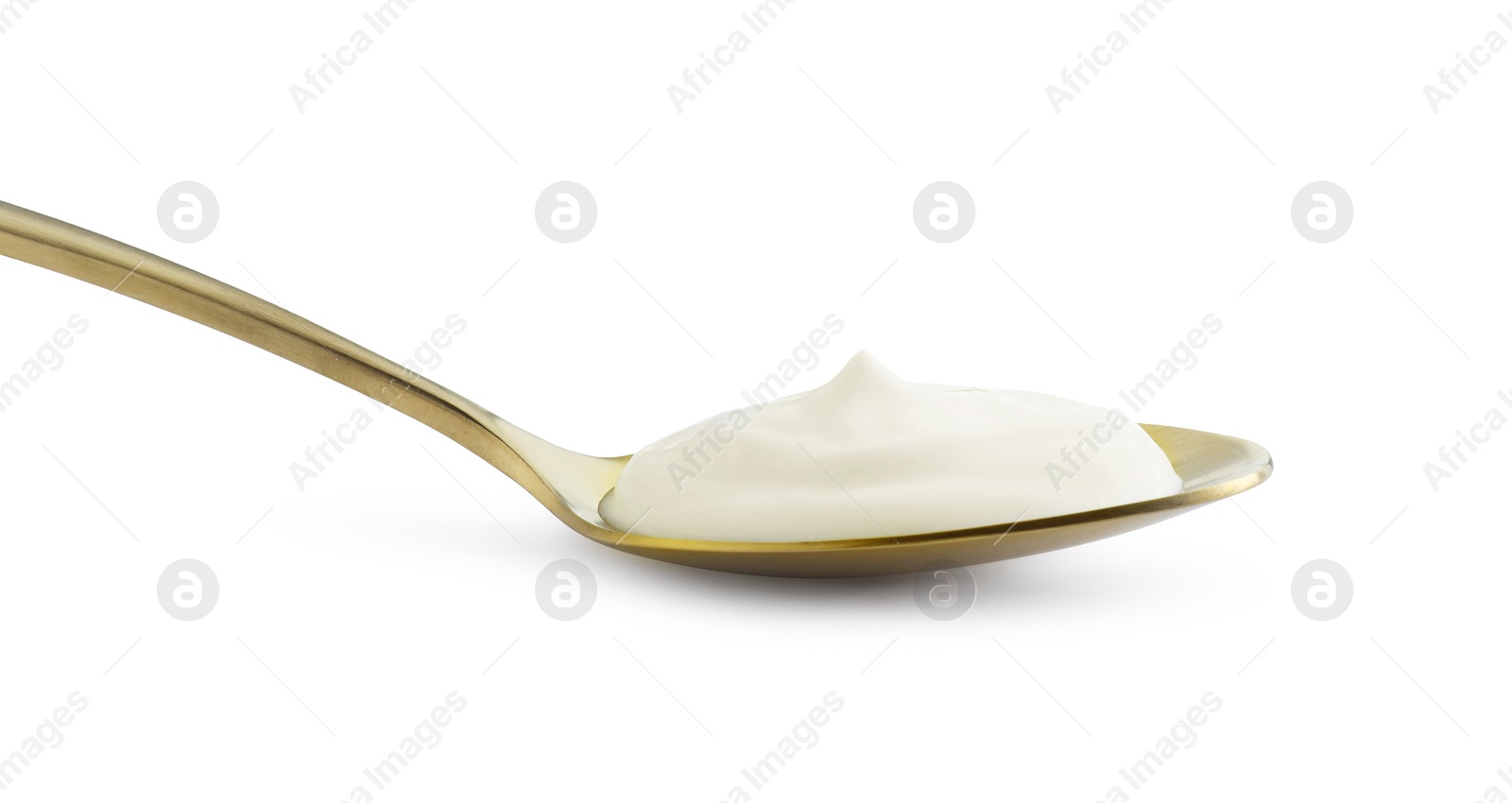 Photo of Golden spoon with sour cream isolated on white