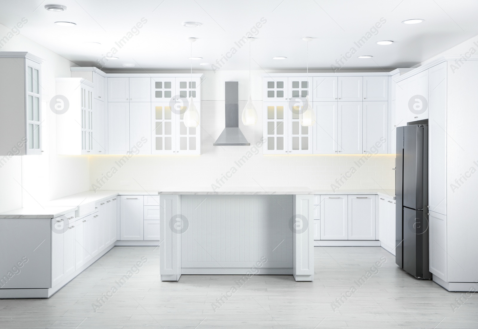 Photo of Interior of modern light kitchen with stylish furniture