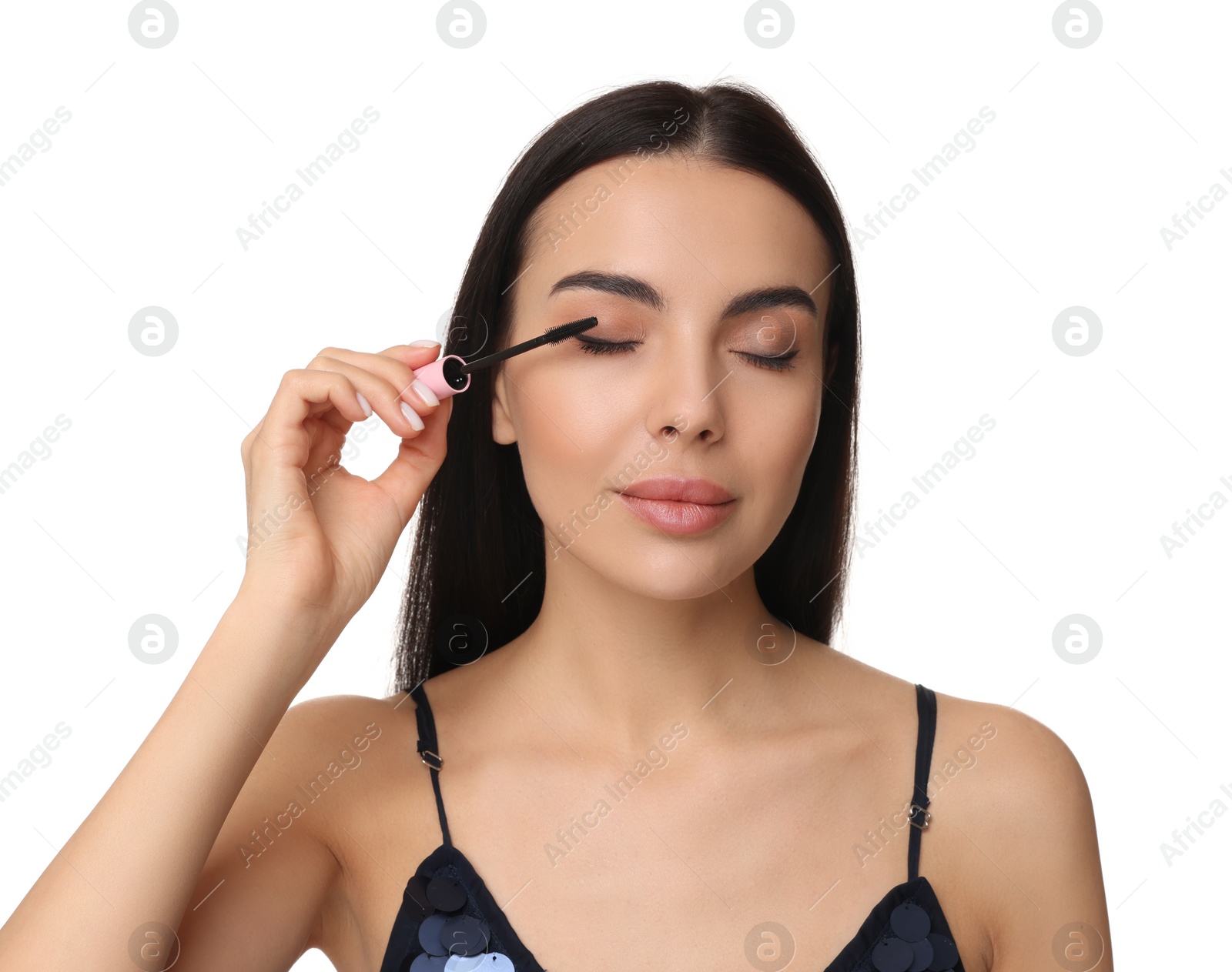 Photo of Young woman applying mascara on white background