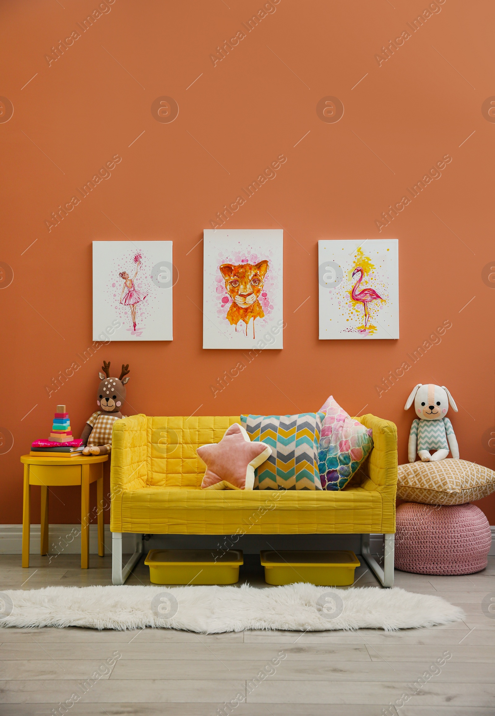 Photo of Cute pictures and comfortable sofa  in baby room interior