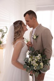 Photo of Happy bride and groom indoors. Wedding day