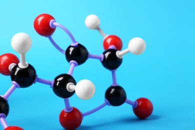 Photo of Molecule of vitamin C on light blue background, closeup. Chemical model