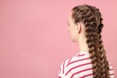 Photo of Woman with braided hair on pink background