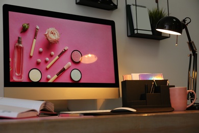 Photo of Modern workplace interior with computer on table