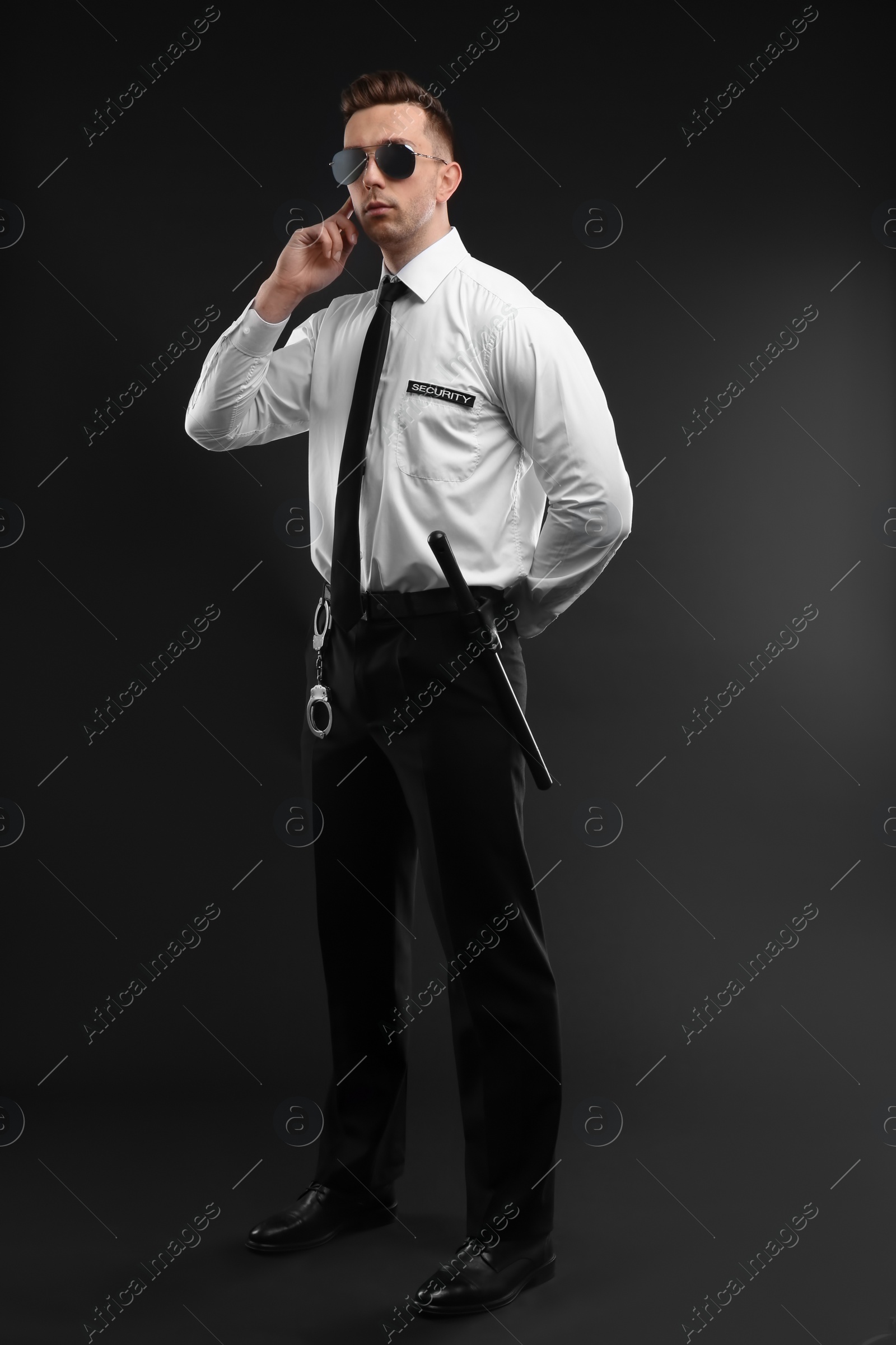 Photo of Male security guard in uniform on dark background