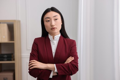 Portrait of notary with crossed arms in office