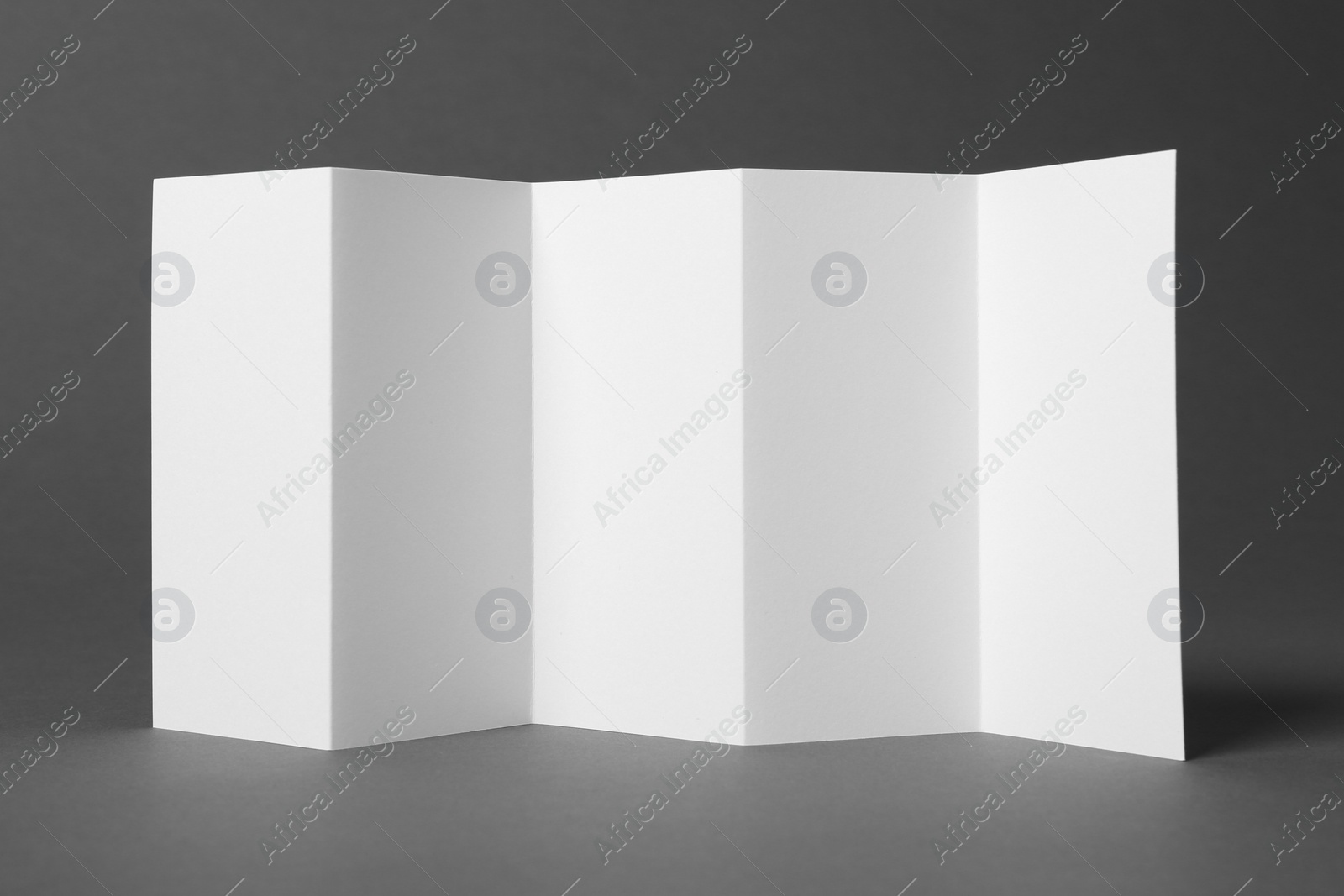 Photo of Blank brochure on gray background. Mock up for design