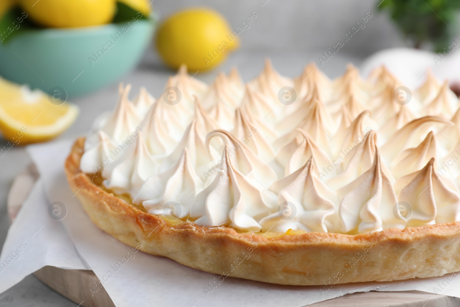 Photo of Delicious lemon meringue pie on board, closeup