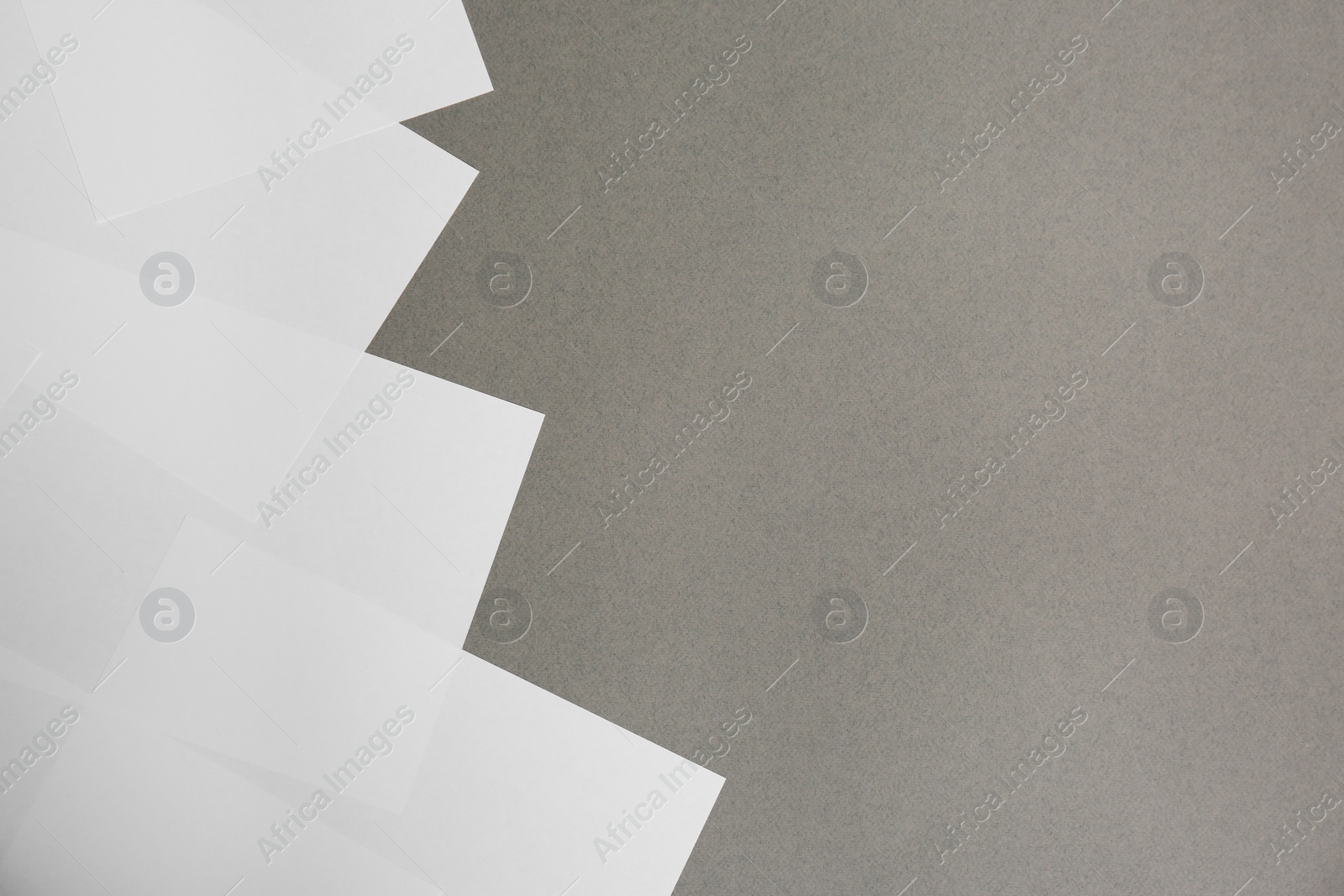 Photo of Blank white paper sheets on grey background, flat lay. Space for text