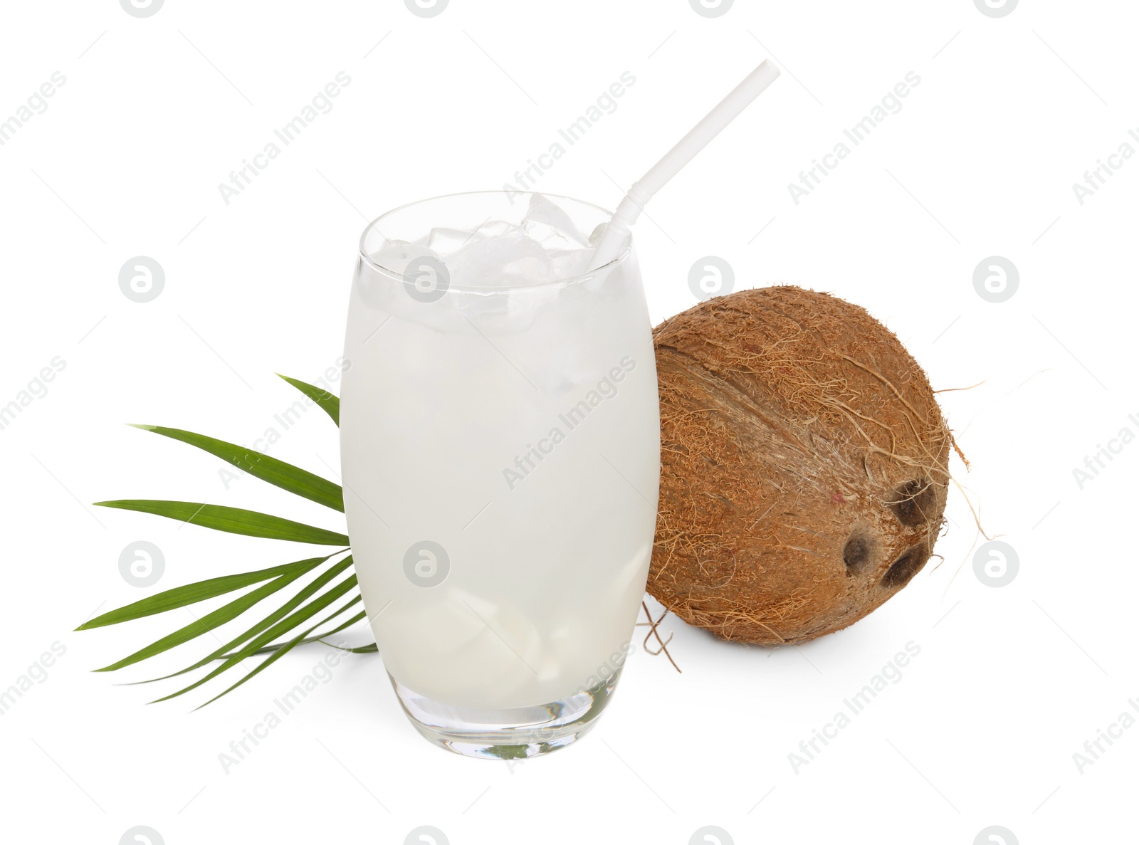 Photo of Glass of coconut water, ice cubes, leaf and nut isolated on white