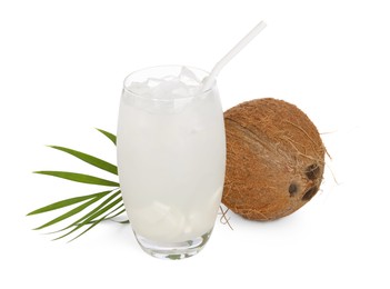 Photo of Glass of coconut water, ice cubes, leaf and nut isolated on white