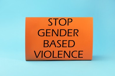 Photo of Card with text Stop Gender Based Violence on light blue background