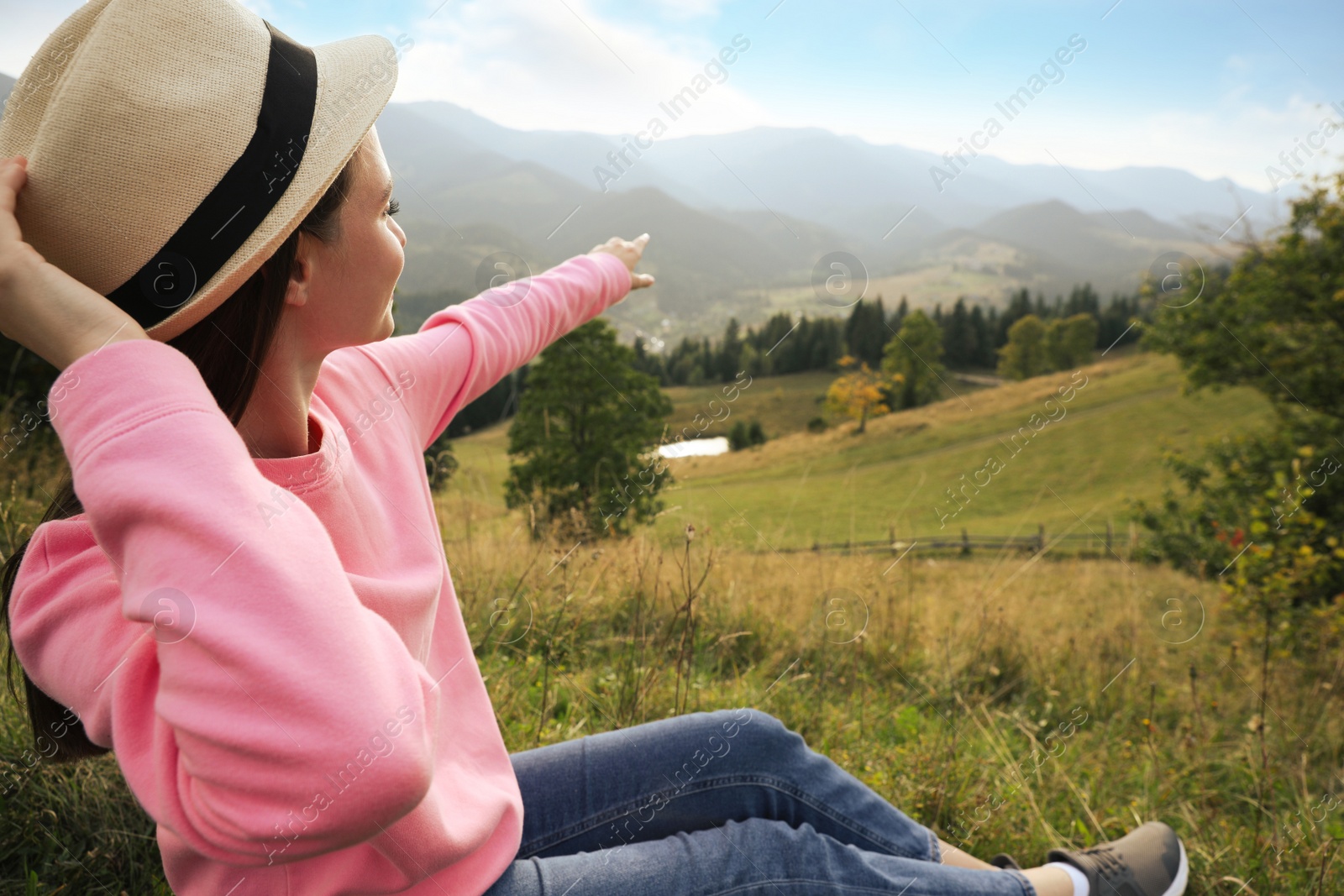 Photo of Young woman enjoying beautiful view of mountain landscape. Space for text