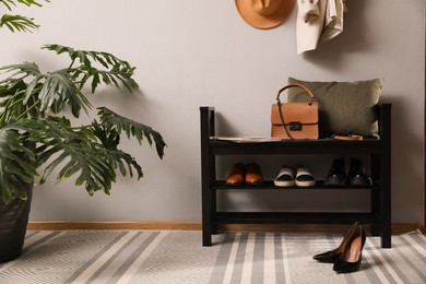 Photo of Hallway interior with stylish furniture, clothes and accessories