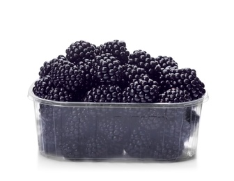 Photo of Plastic container with tasty blackberries on white background