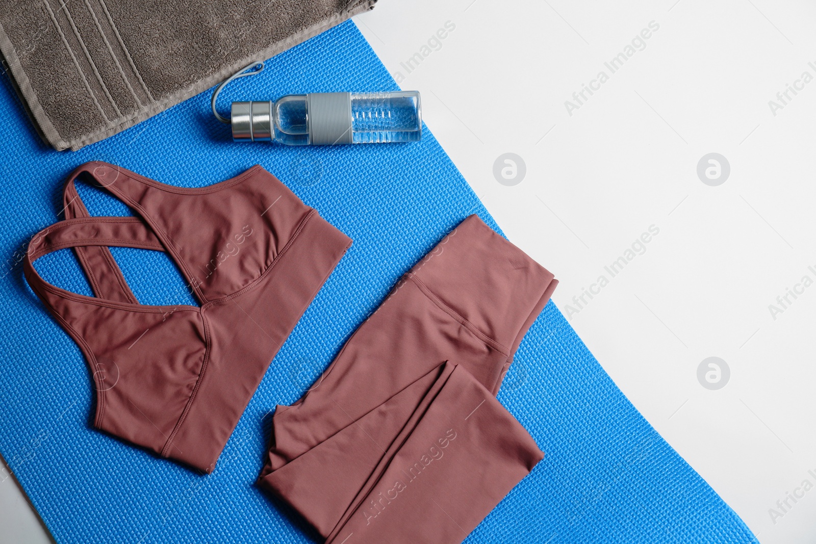 Photo of Flat lay composition with yoga equipment on grey background