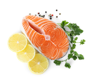 Photo of Fresh raw salmon with pepper, lemon and parsley on white background, top view. Fish delicacy